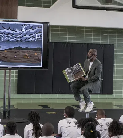 a person sitting on a chair in front of a crowd