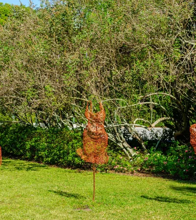 a group of trees with a deer statue in the middle