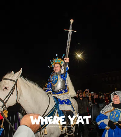 a person in a garment riding a horse with a crowd watching