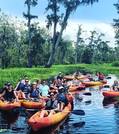 a group of people in canoes on a river