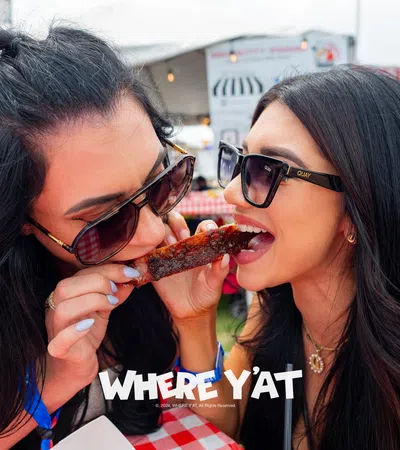 a couple of women eating pizza