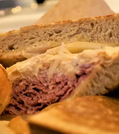 a sandwich with chips and salsa