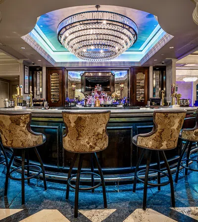 a bar with a large bar and chairs