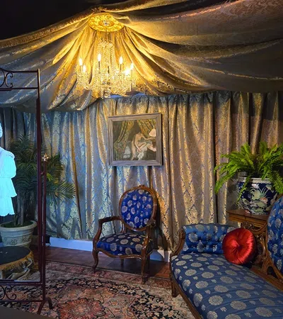 a room with a painting and chairs