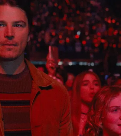 Josh Hartnett holding a cell phone in a crowd
