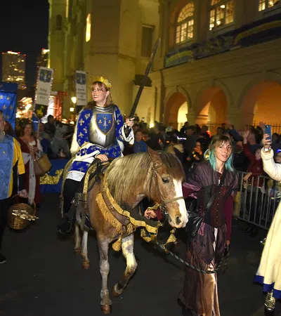 a person riding a horse in a crowded street