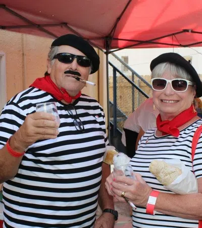a couple of people wearing sunglasses and holding food