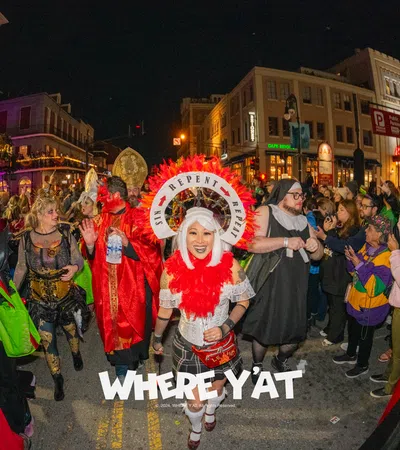 a group of people in clothing on a street at night