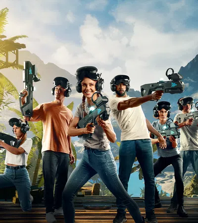 Group of people wearing VR headsets and holding futuristic gaming guns in a tropical mountain environment