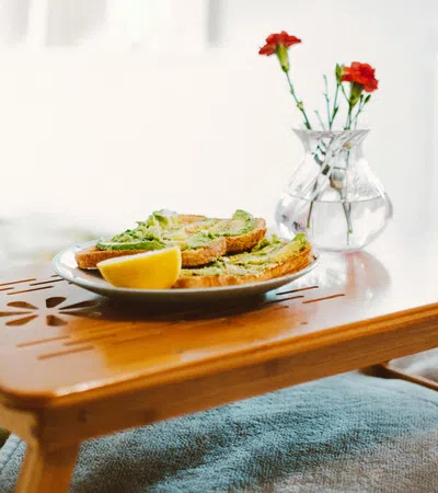 a plate of food and a vase of flowers on a table