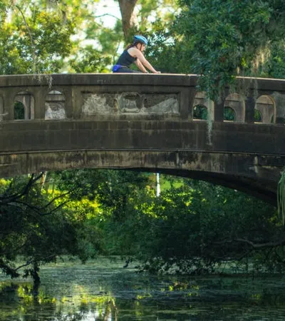 a person sitting on a bridge over water