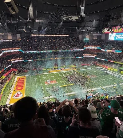 a sports stadium with a field and people in it
