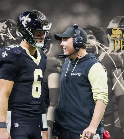 New Orleans Saints player and coach discussing during game with team preview text and strategy graphics overlay.