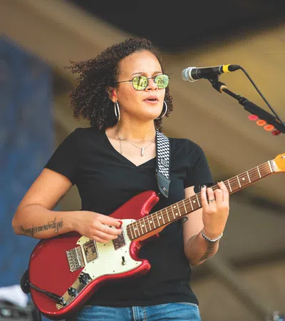 Mia Borders playing a guitar