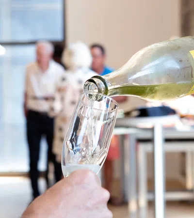 a hand holding a bottle of liquid