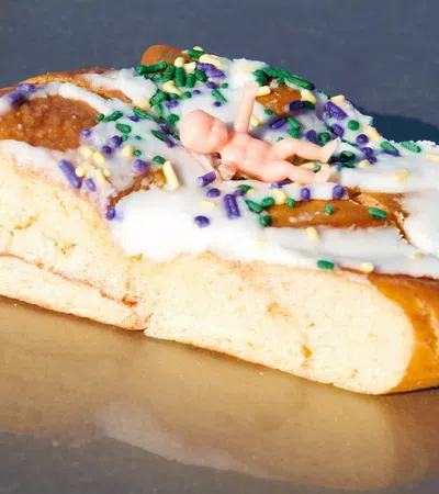 a piece of bread with colorful frosting and sprinkles on it