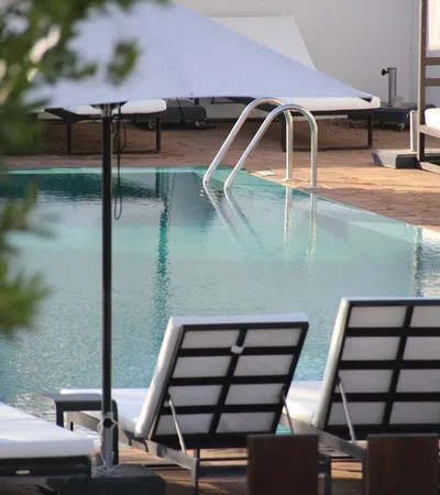 a pool with chairs around it