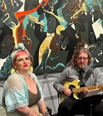a man and woman playing guitar