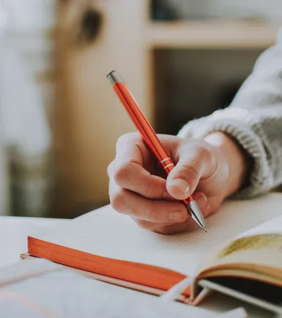 a person writing on a book