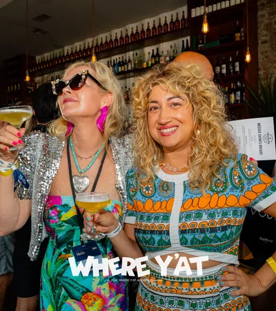 a couple of women holding drinks