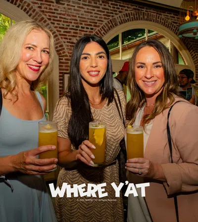 a group of women holding glasses of beer
