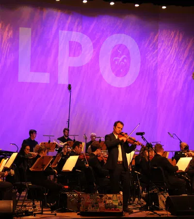a group of people playing instruments on a stage