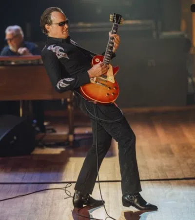 a person playing a guitar on a stage
