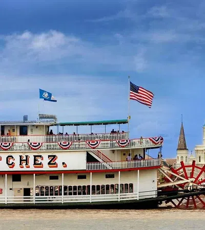 Steamboat Natchez on the Mississippi River, with New Orleans skyline in the background.