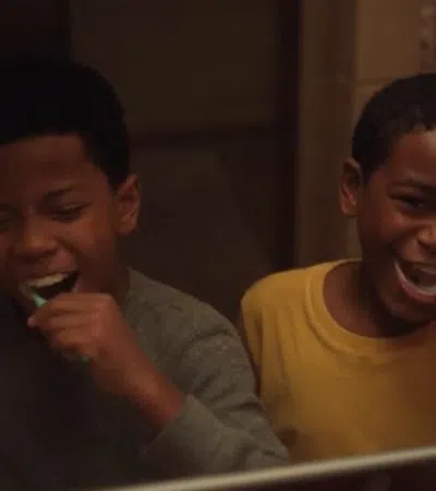 a couple of boys brushing their teeth