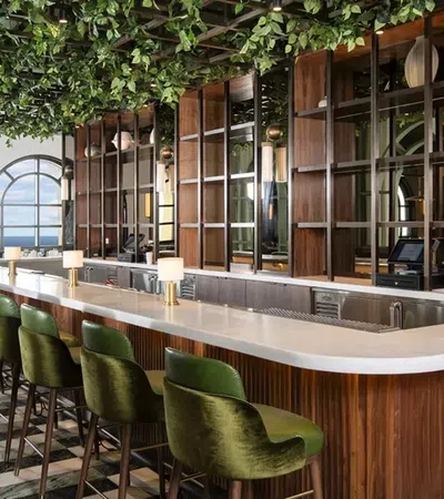 a bar with green chairs