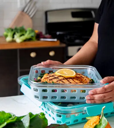 a person putting food in a dish