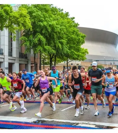 Runners starting the Crescent City Classic event, with branding and participant guide details.