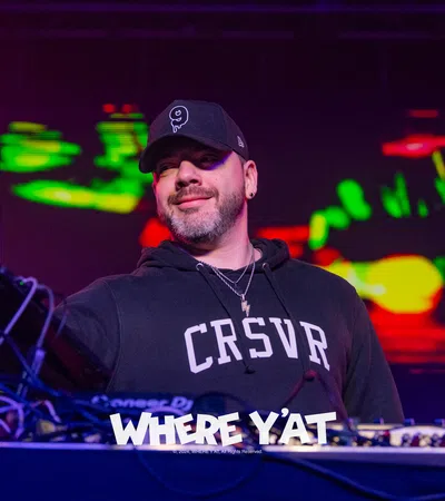 a man wearing a hat and a black shirt with a microphone