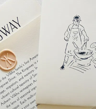 The Kingsway card with a wax seal and a sketch of two people cooking together on cream paper.