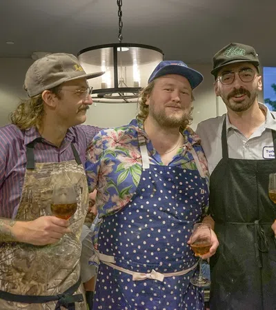 a group of men holding wine glasses