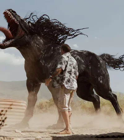 a person standing next to a large animal with horns