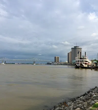 a body of water with a boat in it and buildings in the back