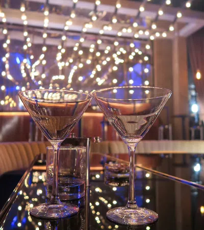 a couple of wine glasses on a bar