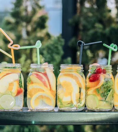 a group of glass jars with fruit in them