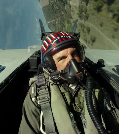 a person in a military uniform flying a plane