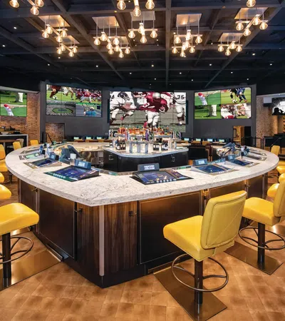 a bar with yellow chairs