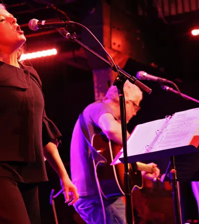 a man and woman playing instruments