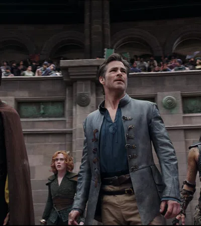 a group of people standing in front of a building with a large group of people in the background