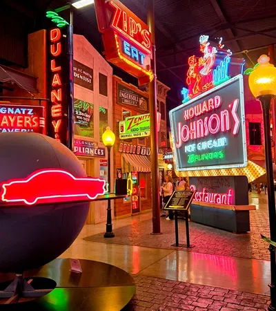 Colorful neon signs inside a retro diner-style atmosphere creating a vibrant ambiance.