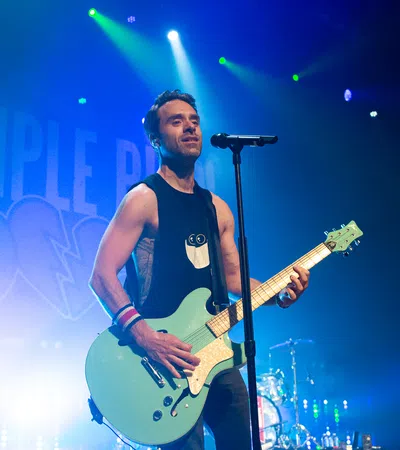 Sebastien Lefebvre playing a guitar on a stage