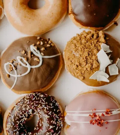 a group of donuts with frosting and sprinkles