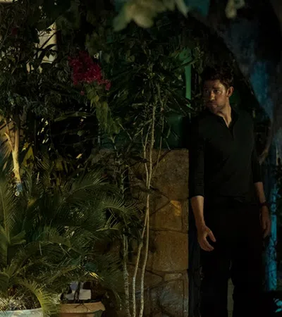 a man standing next to a tree