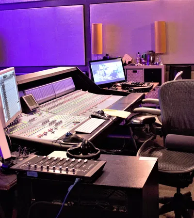 a desk with a laptop computer sitting on top of a table