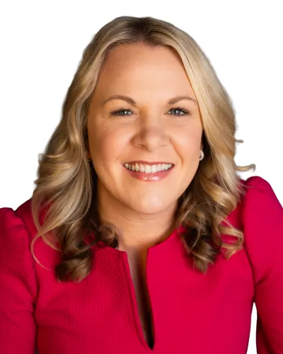 Smiling woman with blonde hair wearing a red textured top against white background, looking confident and approachable