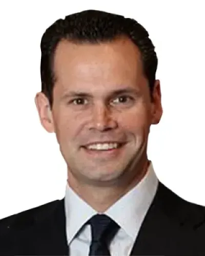 Smiling man in black suit and blue tie with white dress shirt on white background